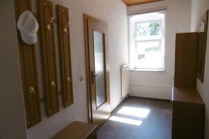 an empty room with a door and a window at Ferienwohnung Rauscher in Kurort Altenberg