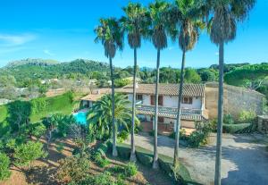 an aerial view of a house with palm trees at Owl Booking Villa La Font - Relax with a Big Pool in Pollença