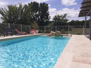 a swimming pool with at restyled bohemian mobil home la vie en rose in Montcléra