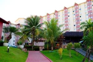 un gran edificio con palmeras y una acera en HOT SPRINGS HOTEL Caldas Novas-FLAT VIP, en Caldas Novas