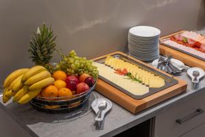 a tray of cheese and fruit on a counter at SKY Hotel Prague in Prague