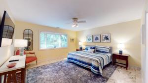 a bedroom with a bed and a desk and a window at 2 Off Shore in Hilton Head Island +28 photos
