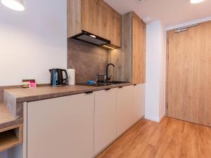a kitchen with white cabinets and a counter top at VacationClub – Jantaris Apartament B35 in Mielno