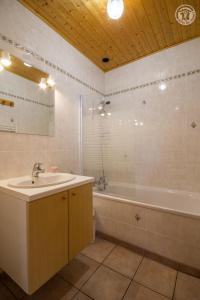 a bathroom with a sink and a bath tub at La Tomba Val-Cenis Lanslevillard in Lanslevillard +11 photos