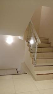 a staircase in a house with white stairs and lights at Apartamentos Mykonos in Las Toninas +1 photo