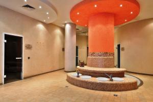 a lobby with a fountain in the middle of a room at Bellevue Residence Apartments in Bansko