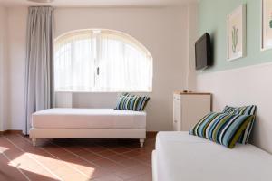 a living room with a white couch and a window at Lido Azzurro in Numana