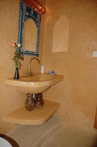 a bathroom with a sink and a mirror at Riad Jade Mogador in Essaouira