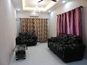 sala de estar con sofá negro y mesa en D'Haja 56 KLIA SEPANG with 3 AIRCONDS & FREE Wi-Fi en Banting