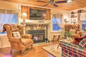 a living room with two chairs and a fireplace at Private and Cozy Chimney Rock Abode with Fire Pit in Chimney Rock