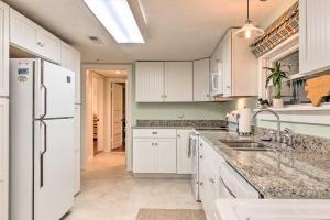 a kitchen with white cabinets and a white refrigerator at Private and Cozy Chimney Rock Abode with Fire Pit in Chimney Rock