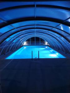 a swimming pool with blue lights in a tunnel at Omalos Village in Omalós