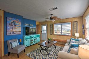 a living room with a couch and a table at Colorful Crystal Beach Home with Ocean View! in Crystal Beach