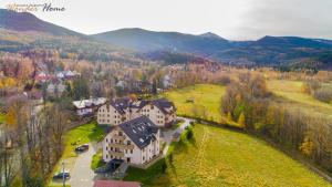 an aerial view of a large house in the mountains at Wonder Home - Apartamenty w malowniczej, spokojnej okolicy - z widokiem na Śnieżkę in Karpacz