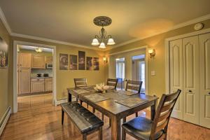 a dining room with a wooden table and chairs at Spacious Home by Finger Lakes and Watkins Glen! in Burdett