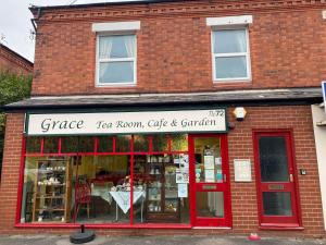 a store front of a brick building with a table in it at Grace Stays in Ellesmere Port