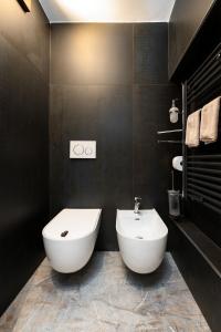 a bathroom with a white toilet and a sink at F1RST Suite Apartment & SPA in Florence
