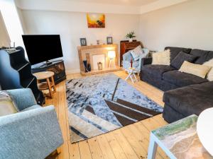 a living room with a couch and a tv at Granny's in Bushmills