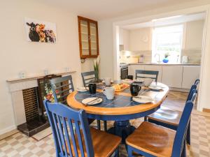 a kitchen and dining room with a table and chairs at Granny's in Bushmills