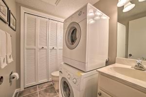 a white laundry room with a washer and a sink at Cozy Family Home with Fireplace Less Than 1 Mi to Lake! in Harbor Springs