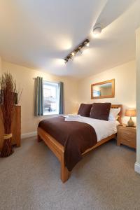 a bedroom with a large bed and a window at Swan Place Apartments By Viridian Apartments in Swindon