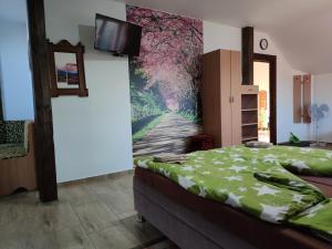 A bed or beds in a room at András penzión