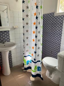 a bathroom with a shower curtain with stars on it at Ndaary Khassoum in Ziguinchor