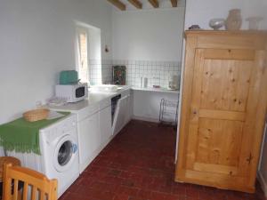 a kitchen with a washing machine and a sink at Charmante maison in Grand Bailly