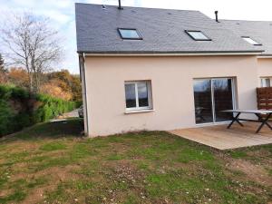 a house with a picnic table on a deck at La bellangerie in Joue-les-Tours