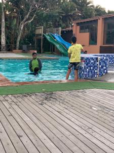 two young boys playing in a swimming pool at San Lameer Holidays in Southbroom