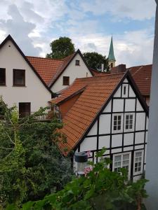 a white and black building with a red roof at Apartment Luxus "Akzente-Art Minden" in Minden