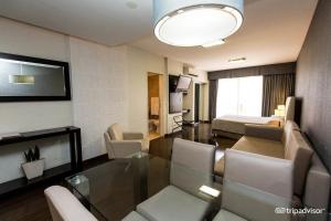 a living room with a glass table and a living room at Ayres Recoleta Plaza in Buenos Aires