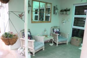 a room with two chairs and a table and a mirror at Lavender Lane Queenstown in Queenstown