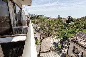 an apartment balcony with a view of a street at Guido 1980 by Ayres Apartments Recoleta in Buenos Aires