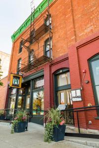 a brick building with a fire escape on a street at Historic Hotel Arvon in Great Falls