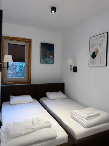 Un ou plusieurs lits dans un hébergement de l'établissement The Nest Apartman, Župa Wellness & Spa Kopaonik