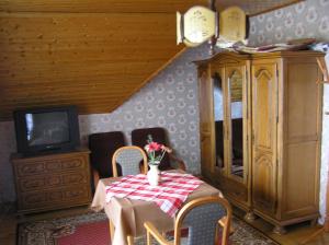 a dining room with a table and a tv at Jakab Ház in Hévíz