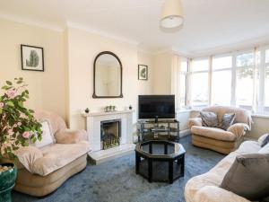 a living room with two chairs and a fireplace at 4 Dorothy Avenue in Skegness