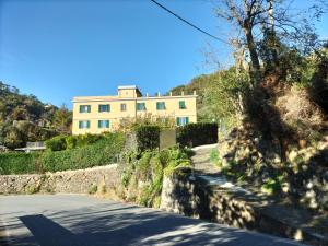 a house on the side of a hill with a road at Green House in Cogoleto
