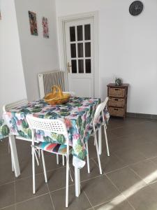 a dining room table with a flowered table cloth at Green House in Cogoleto