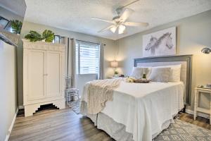 a bedroom with a bed and a ceiling fan at Lanai & Community Pool Access: Sunny Central Condo in Kailua-Kona +22 photos