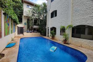a large blue swimming pool next to a building at LA BUENA VIDA CONDO in Tamarindo