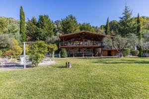 a large building in the middle of a park at ILLE-ROIF resort&SPA in Fara in Sabina