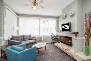 a living room with a couch and a fireplace at Sandman Inn Princeton in Princeton