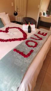 a bed with a heart made out of roses on it at Langa's Gabedi Goshen in Pretoria
