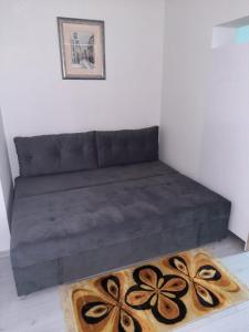 a couch in a room with a rug at Apartman Vuk in Pale