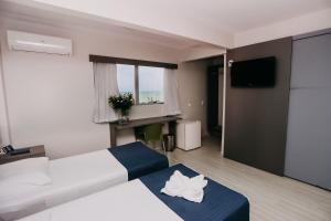 Voodi või voodid majutusasutuse Pajuçara Hotel Express toas