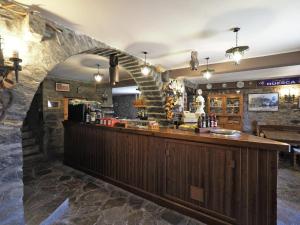 a bar in a restaurant with a stone wall at Casa Lisa in Buerba