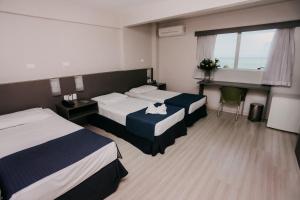 Postel nebo postele na pokoji v ubytování Pajuçara Hotel Express