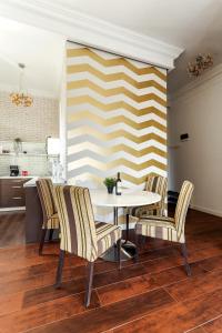 a dining room with a white table and chairs at DD Apartments in Cluj-Napoca